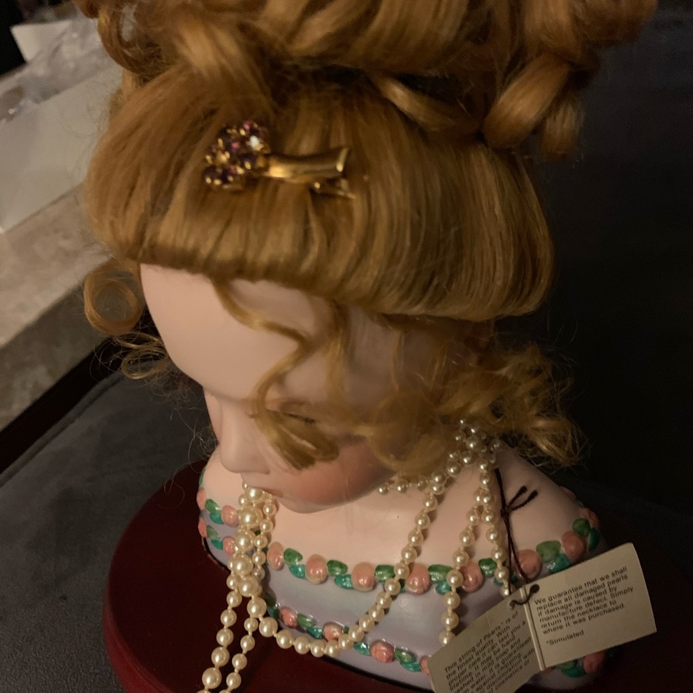 collector ceramic doll with pearls.